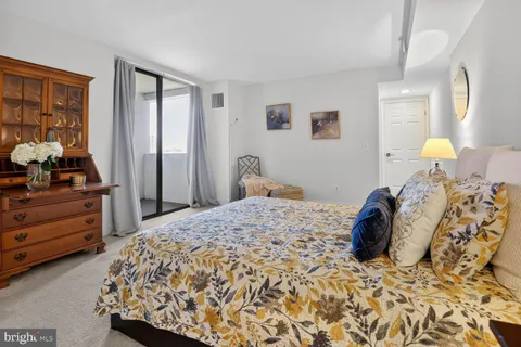 a bed room with a bed and a dresser