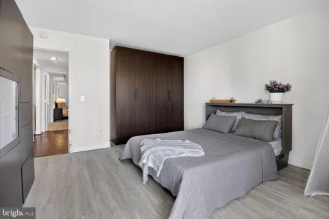 a bedroom with a bed and a chandelier