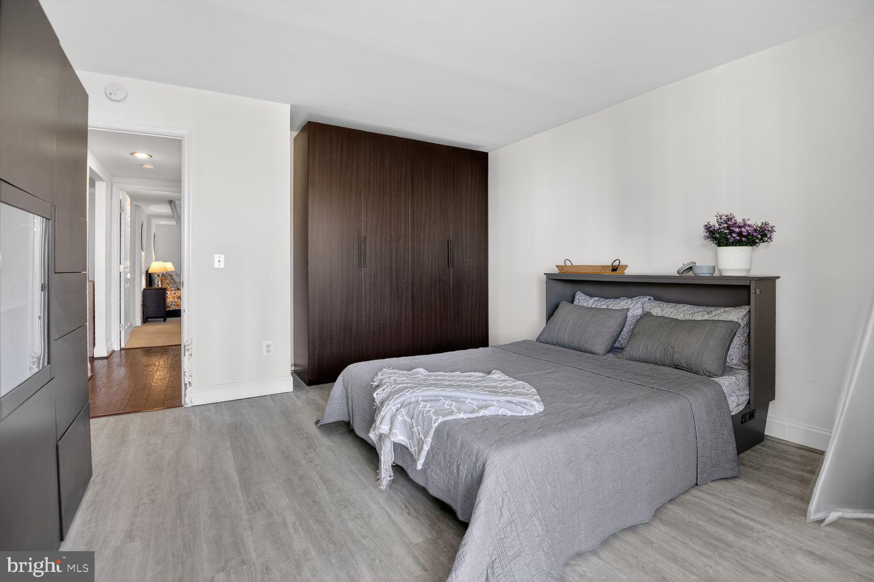 6101 Edsall Road, Unit 1606 Alexandria, VA 22304 - Photo 16 of 31 a bedroom with a bed and a chandelier