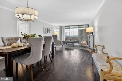 a view of a dining room with furniture wooden floor and chandelier