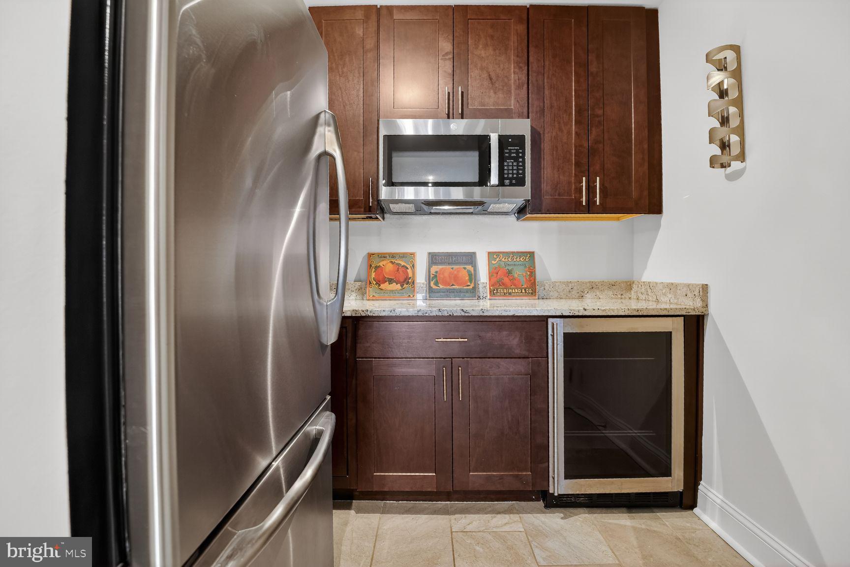 6101 Edsall Road, Unit 1606 Alexandria, VA 22304 - Photo 8 of 31 a kitchen with stainless steel appliances granite countertop a refrigerator and a sink