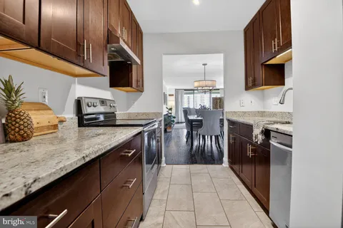 a kitchen with stainless steel appliances granite countertop a sink and stove