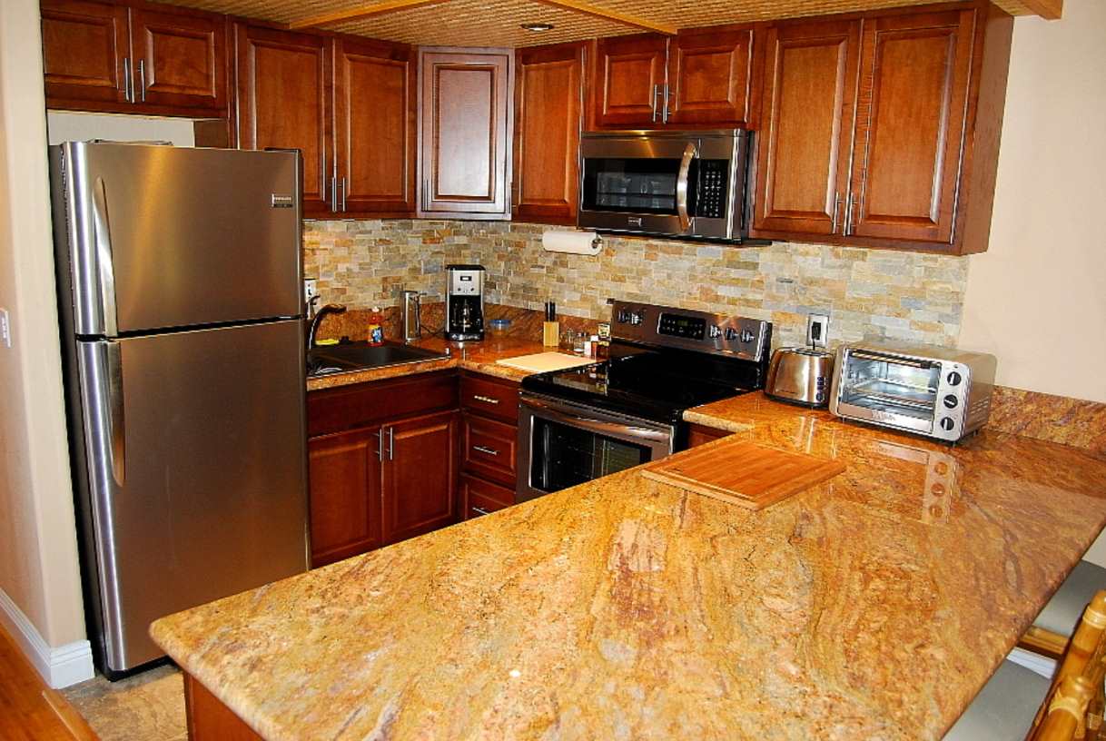 120 Hui F Road, Unit I6 Lahaina, HI 96761 - Photo 2 of 13 a kitchen with stainless steel appliances granite countertop a refrigerator stove top oven a sink and dishwasher