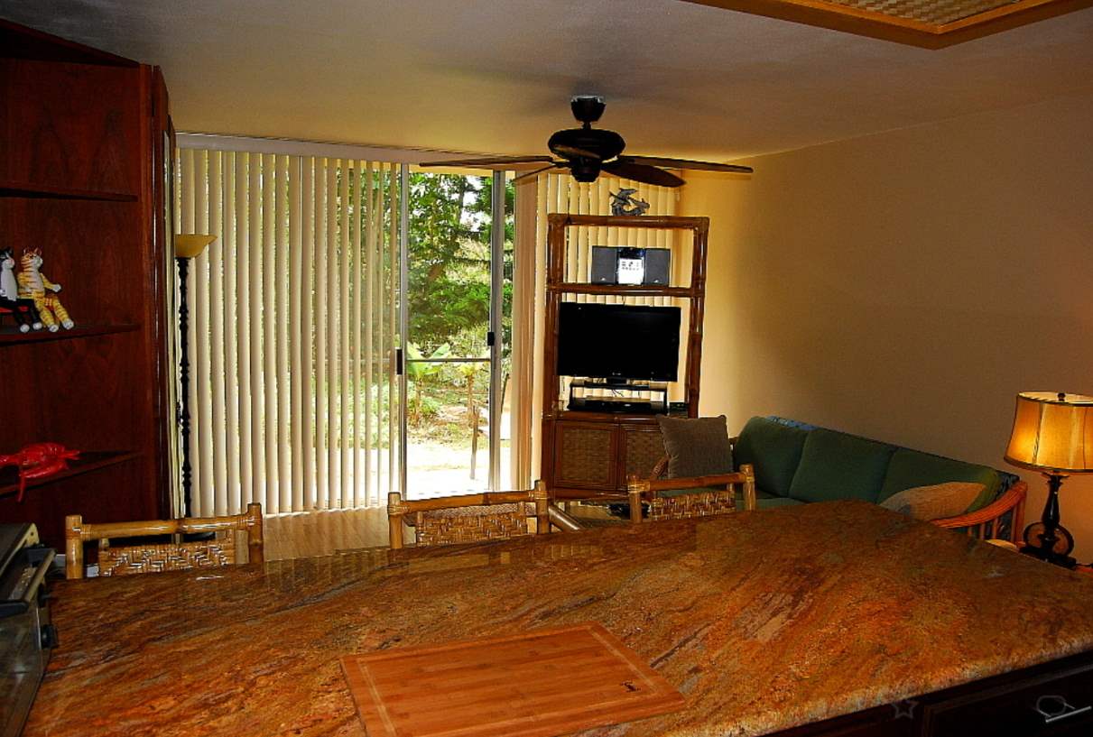 120 Hui F Road, Unit I6 Lahaina, HI 96761 - Photo 3 of 13 a bedroom with a bed and a flat screen tv