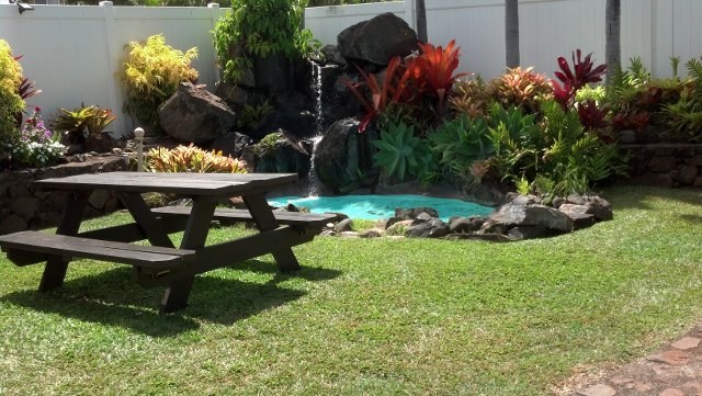 120 Hui F Road, Unit I6 Lahaina, HI 96761 - Photo 9 of 13 a front view of a house with a yard and a fountain