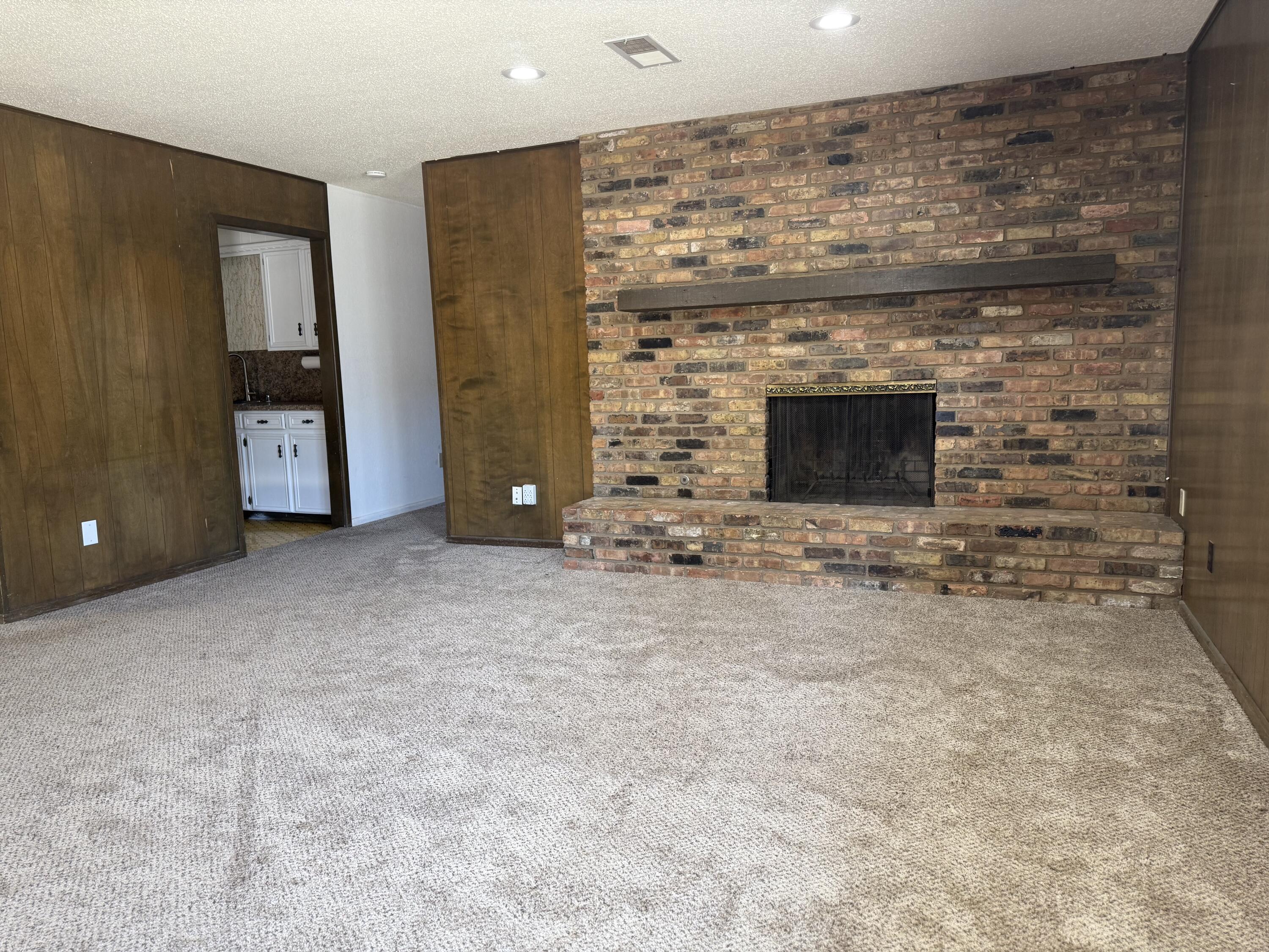 4425 75th Drive, Unit B Lubbock, TX 79424 - Photo 2 of 10 a view of empty room with fireplace