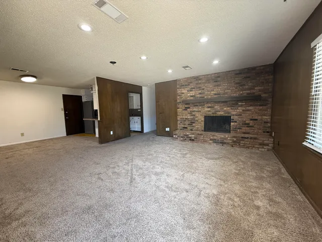 an empty room with furniture and a fireplace