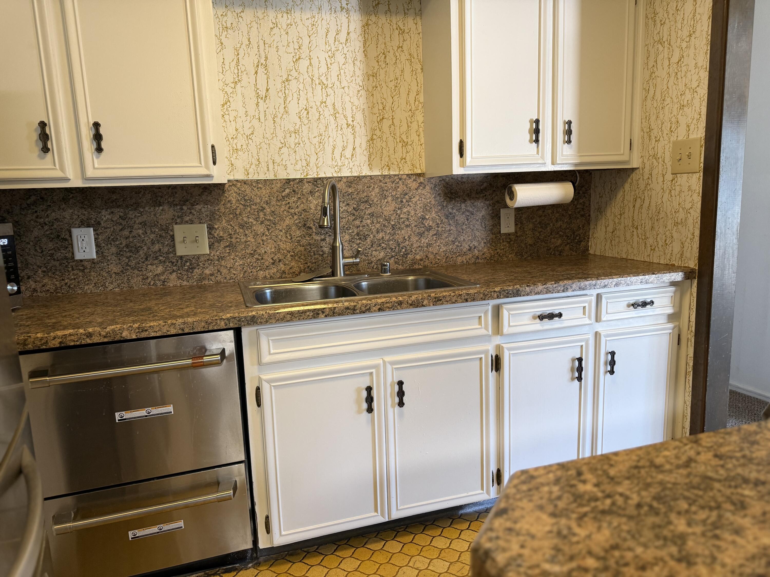 4425 75th Drive, Unit B Lubbock, TX 79424 - Photo 5 of 10 a kitchen with granite countertop white cabinets and sink