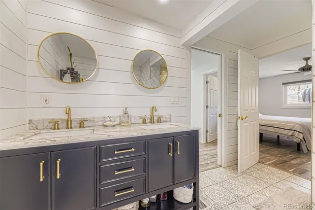 a spacious bathroom with a granite countertop sink and a mirror