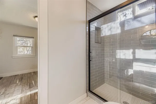 a bathroom with a glass shower door