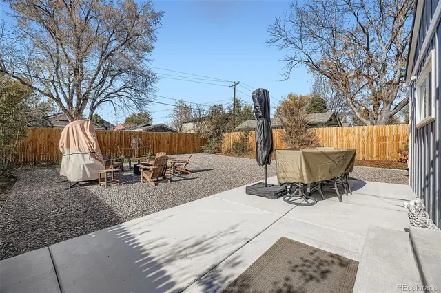 a view of a backyard with table and chairs