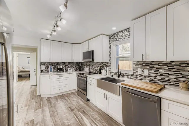 a kitchen with a sink stove and cabinets