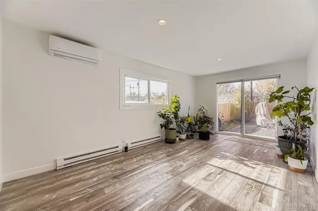 a view of a room with wooden floor and potted plant