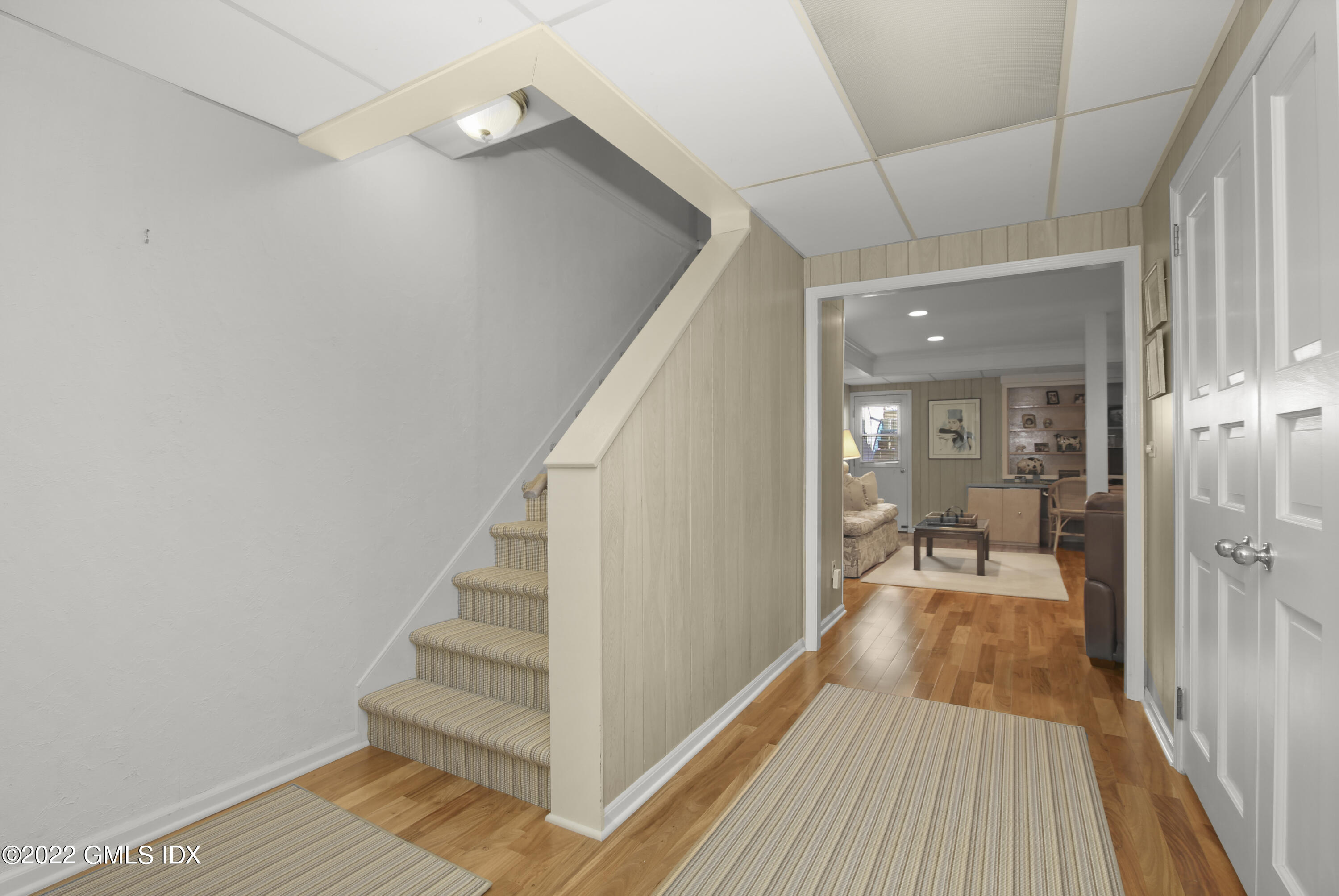 155 Field Point Road, Unit 2N Greenwich, CT 06830 - Photo 11 of 19 a view of a room with wooden floor and staircase