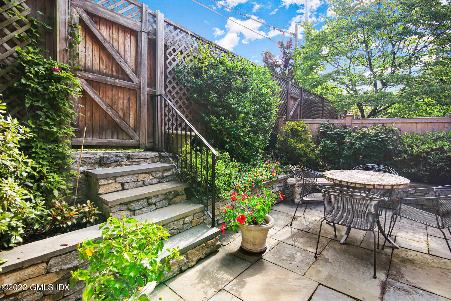 155 Field Point Road, Unit 2N Greenwich, CT 06830 - Photo 13 of 19 a view of a chair and table in backyard with potted plants
