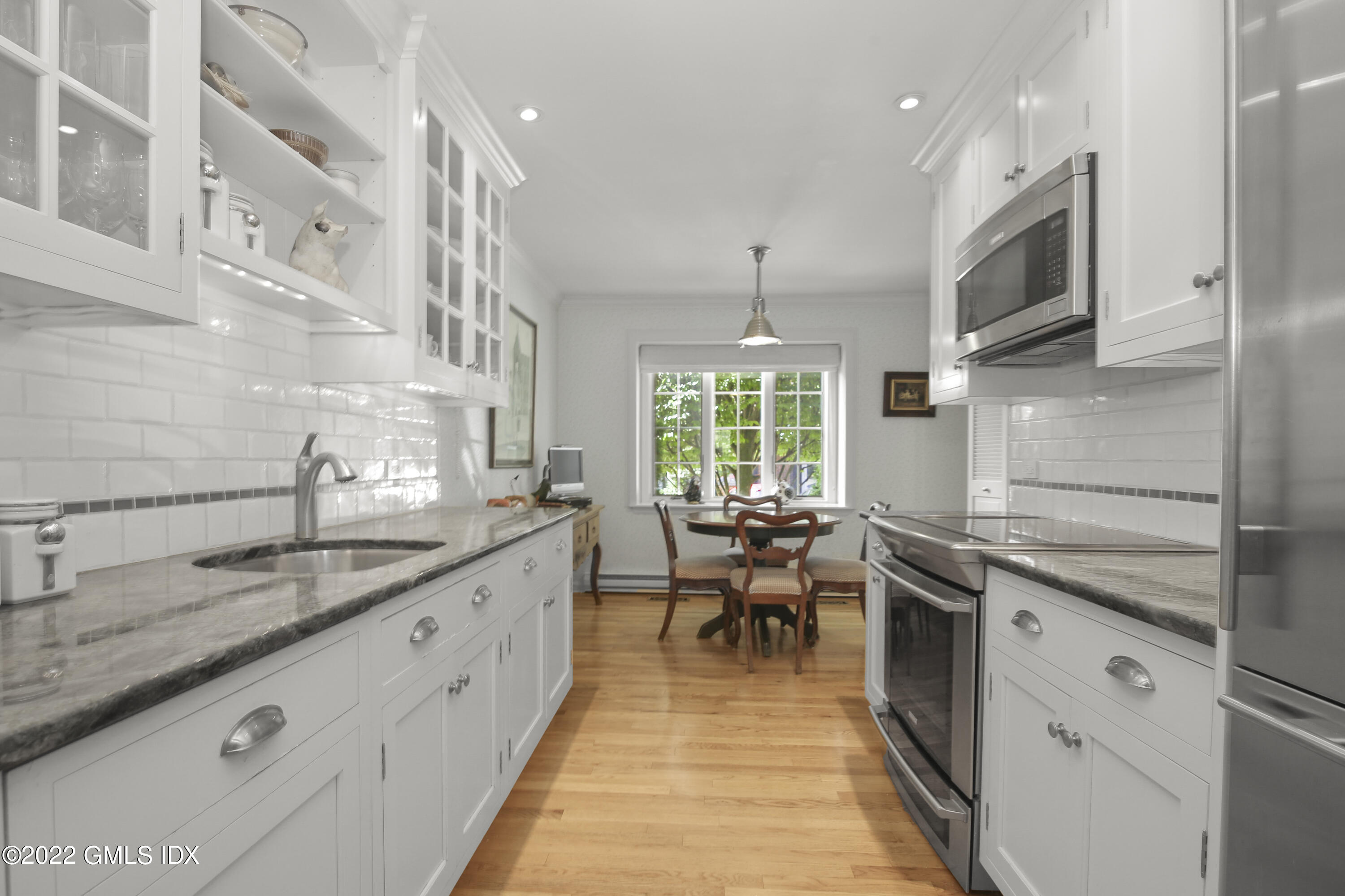 155 Field Point Road, Unit 2N Greenwich, CT 06830 - Photo 4 of 19 a kitchen with stainless steel appliances granite countertop sink stove top oven and cabinets
