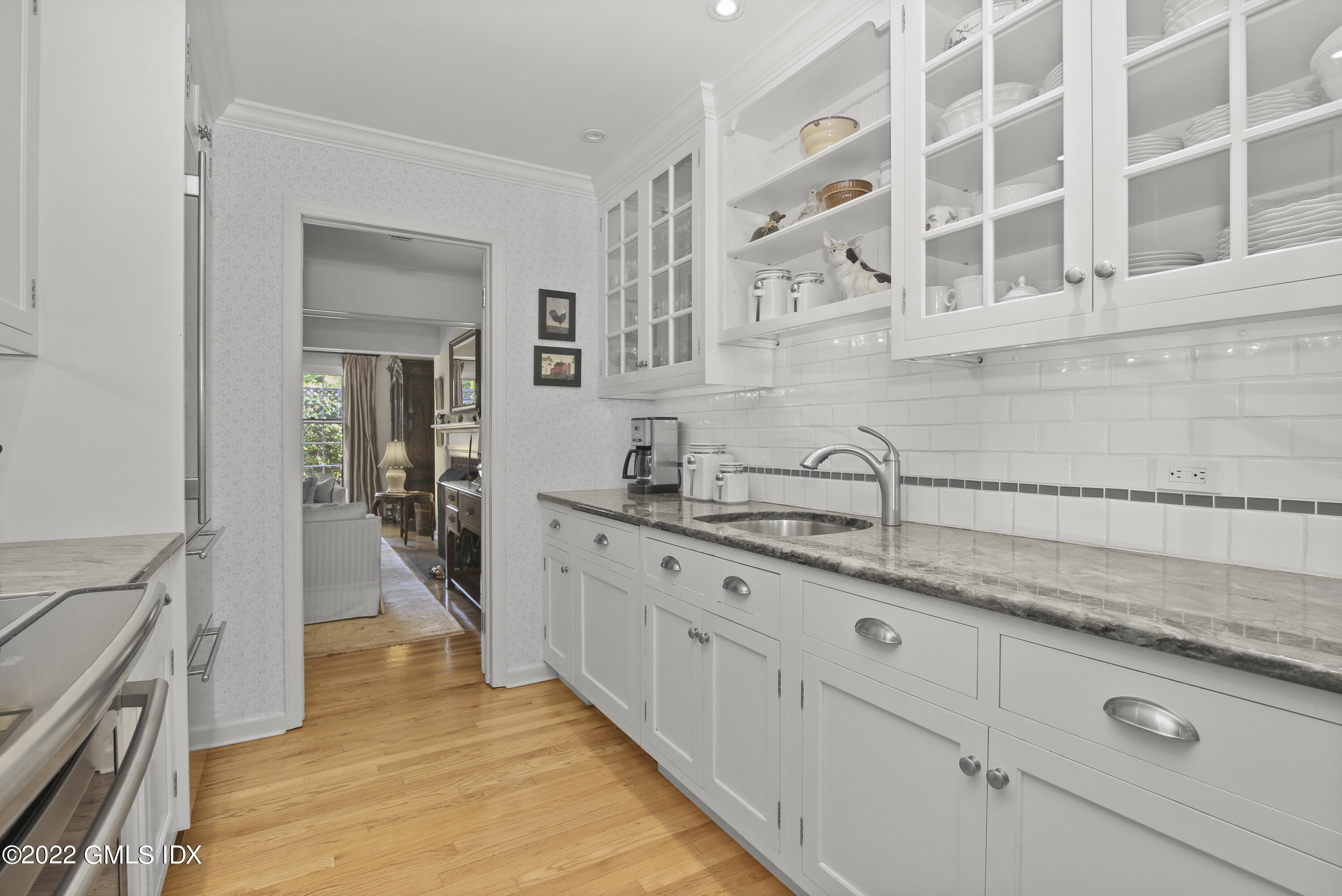 155 Field Point Road, Unit 2N Greenwich, CT 06830 - Photo 5 of 19 a hallway with sink and mirror