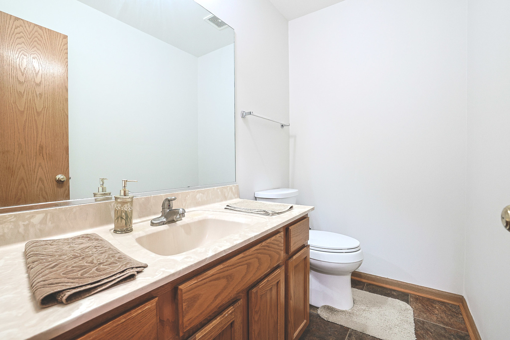 3080 Wagner Road Aurora, IL 60502 - Photo 15 of 31 a bathroom with a granite countertop sink a toilet and a mirror