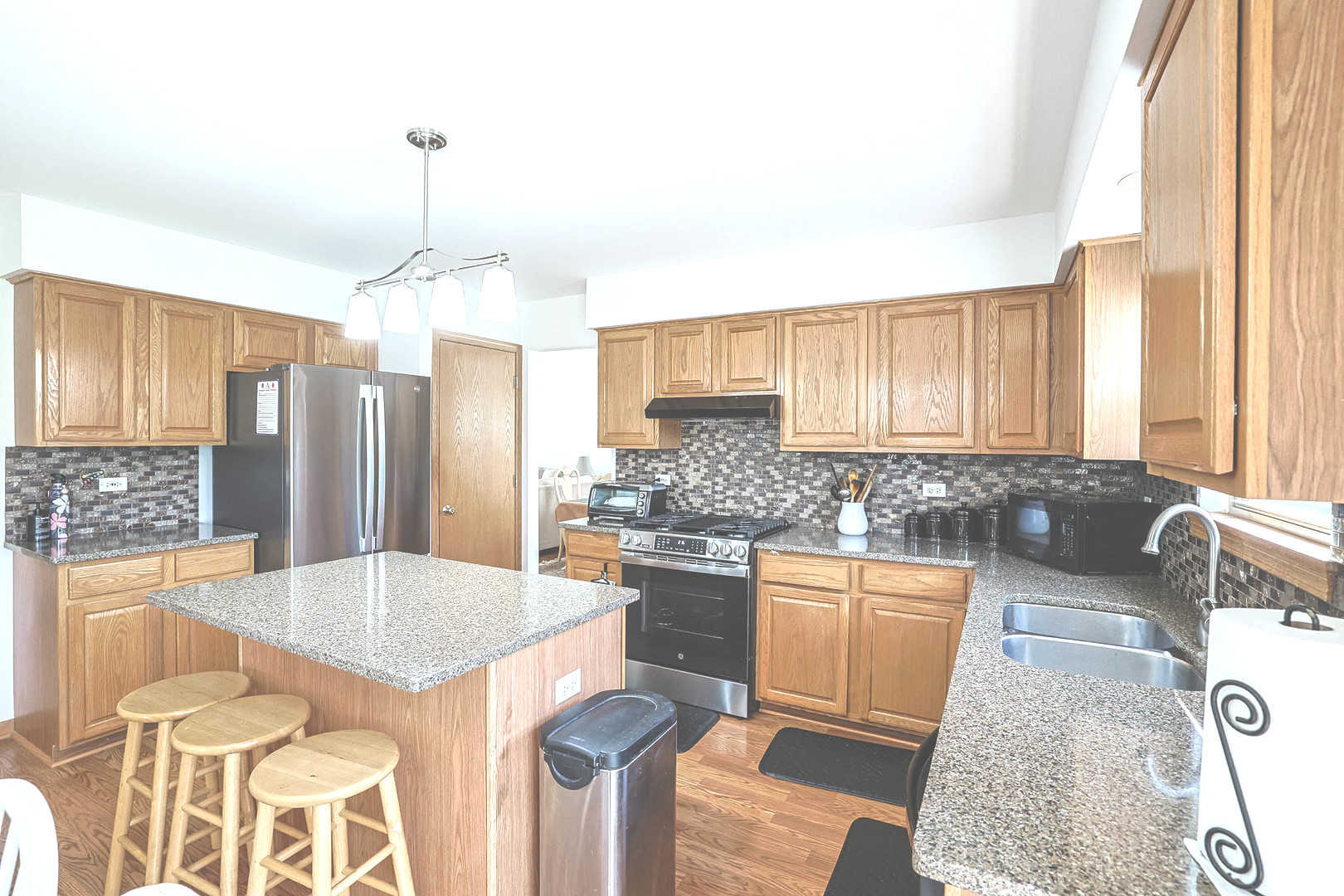 3080 Wagner Road Aurora, IL 60502 - Photo 10 of 31 a kitchen with stainless steel appliances granite countertop a sink stove and refrigerator