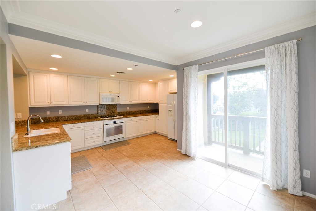 24 Paseo Rosa San Clemente, CA 92673 - Photo 12 of 35 a large white kitchen with a large window