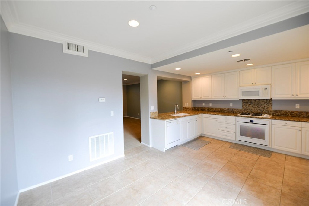 24 Paseo Rosa San Clemente, CA 92673 - Photo 13 of 35 a large kitchen with stainless steel appliances a large counter top and a stove