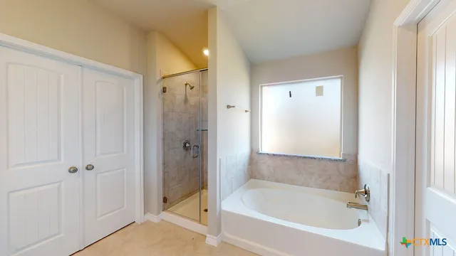 a bathroom with a bathtub and a shower