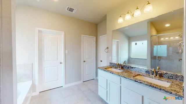 a bathroom with a sink double vanity and a mirror