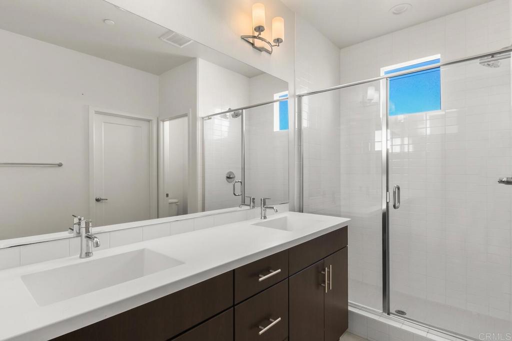 2012 Foxtrot Loop, Unit 3 Chula Vista, CA 91915 - Photo 18 of 34 a bathroom with a sink double vanity and a mirror