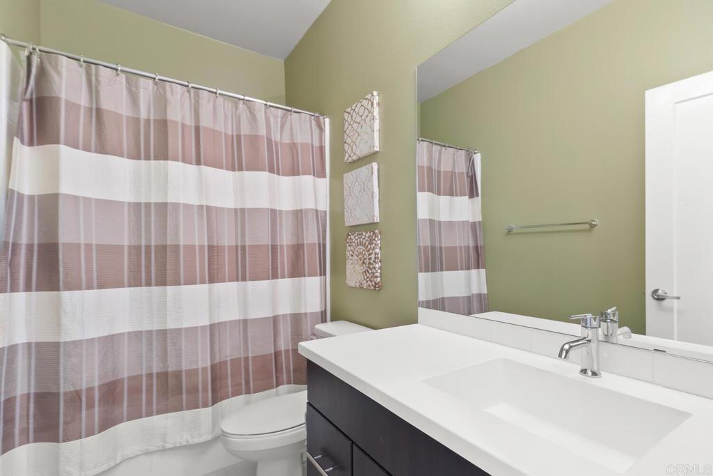 2012 Foxtrot Loop, Unit 3 Chula Vista, CA 91915 - Photo 26 of 34 a bathroom with a sink a toilet and shower curtain