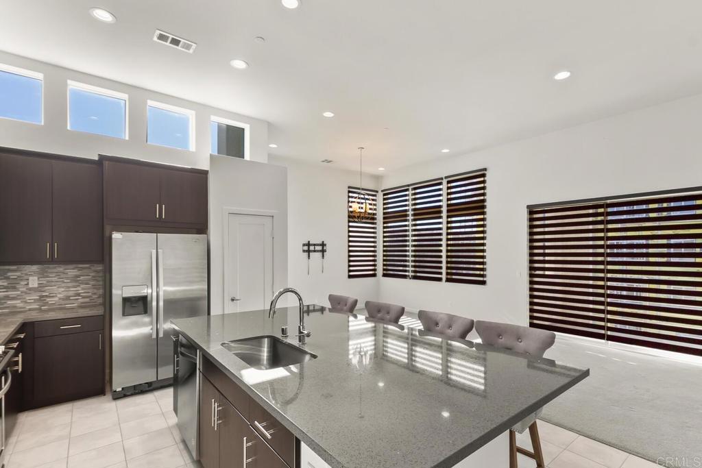 2012 Foxtrot Loop, Unit 3 Chula Vista, CA 91915 - Photo 4 of 34 a kitchen with granite countertop a sink and a refrigerator