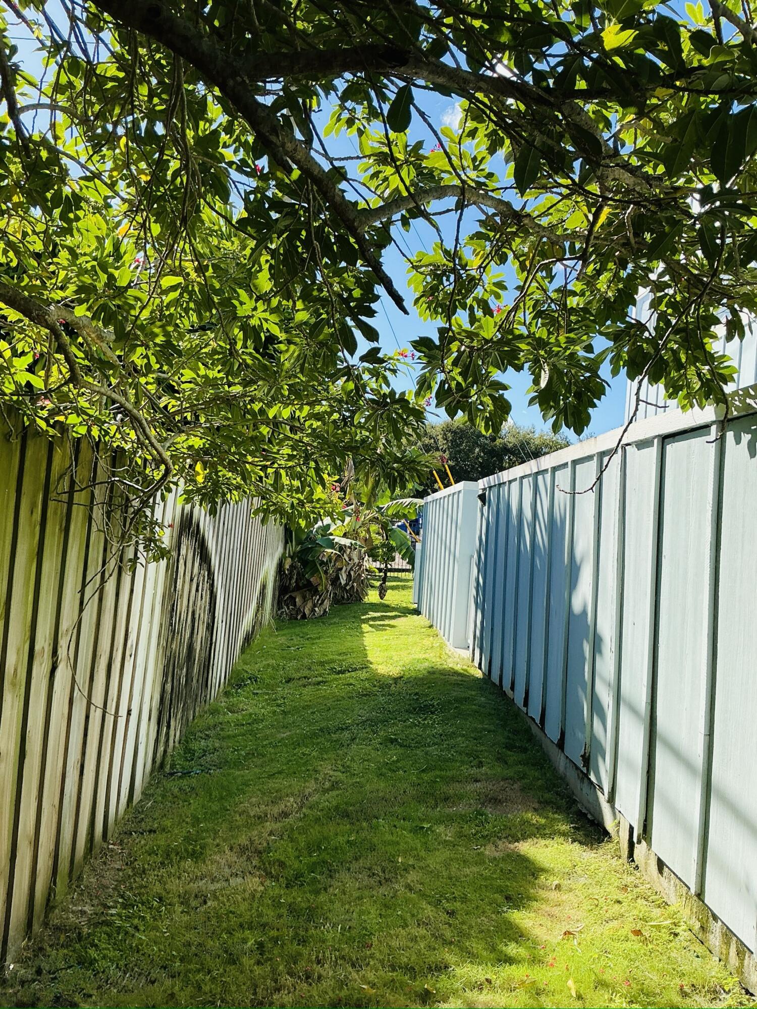 6262 Riverwalk Lane, Unit 3 Jupiter, FL 33458 - Photo 12 of 28 a view of yard with swimming pool and trees