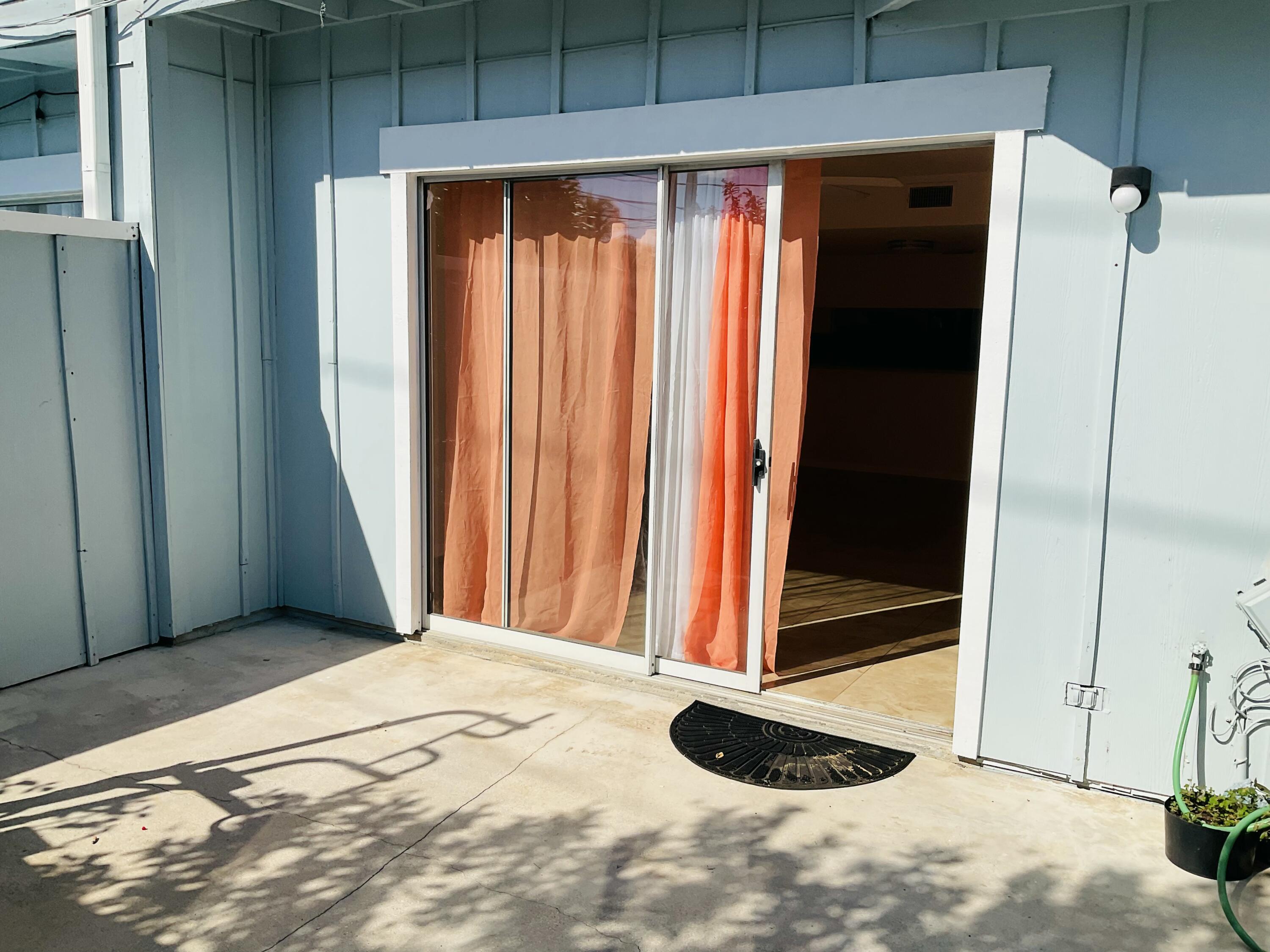 6262 Riverwalk Lane, Unit 3 Jupiter, FL 33458 - Photo 14 of 28 a view of outdoor space and sliding door