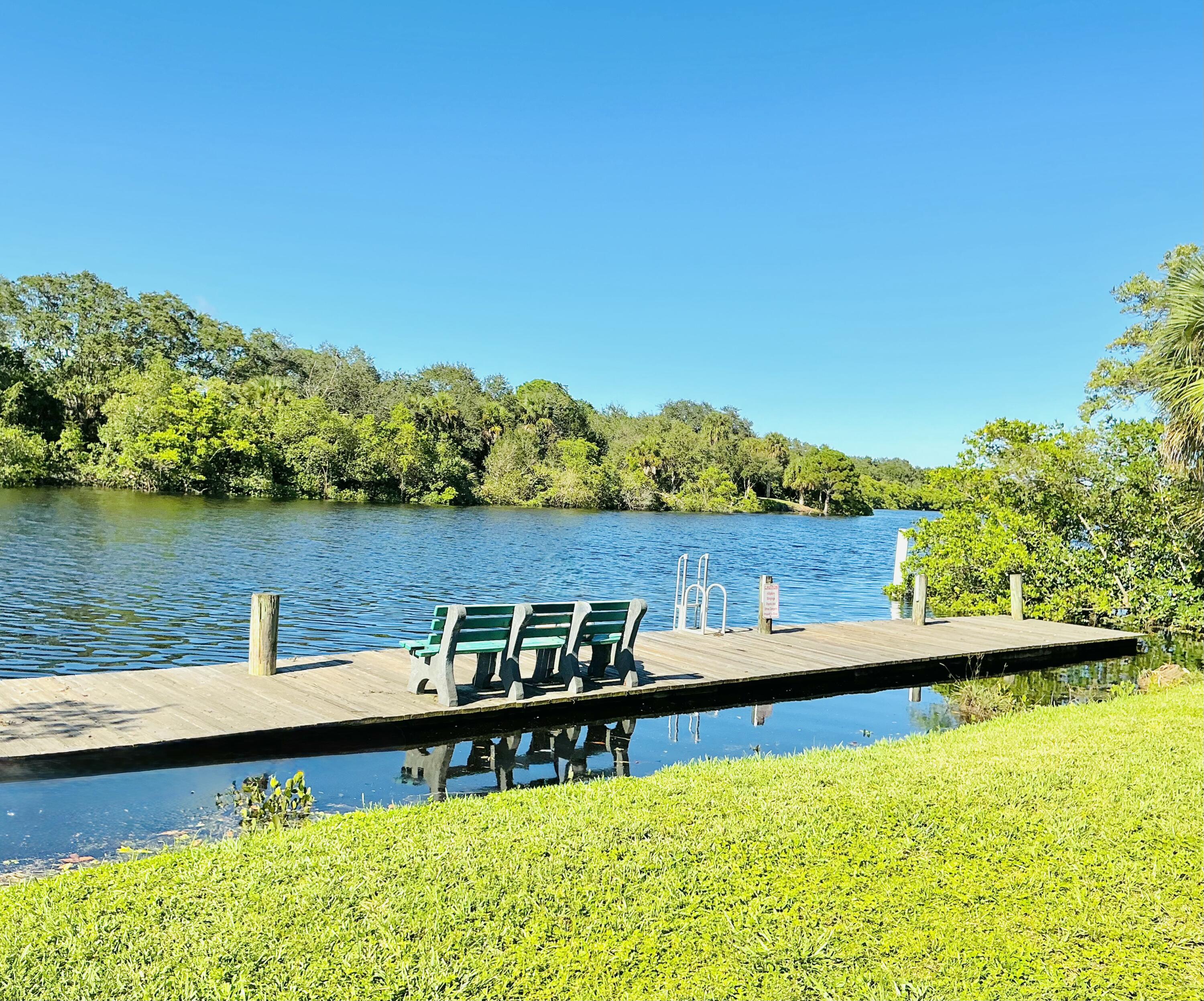 6262 Riverwalk Lane, Unit 3 Jupiter, FL 33458 - Photo 26 of 28 a view of a lake with couches chairs