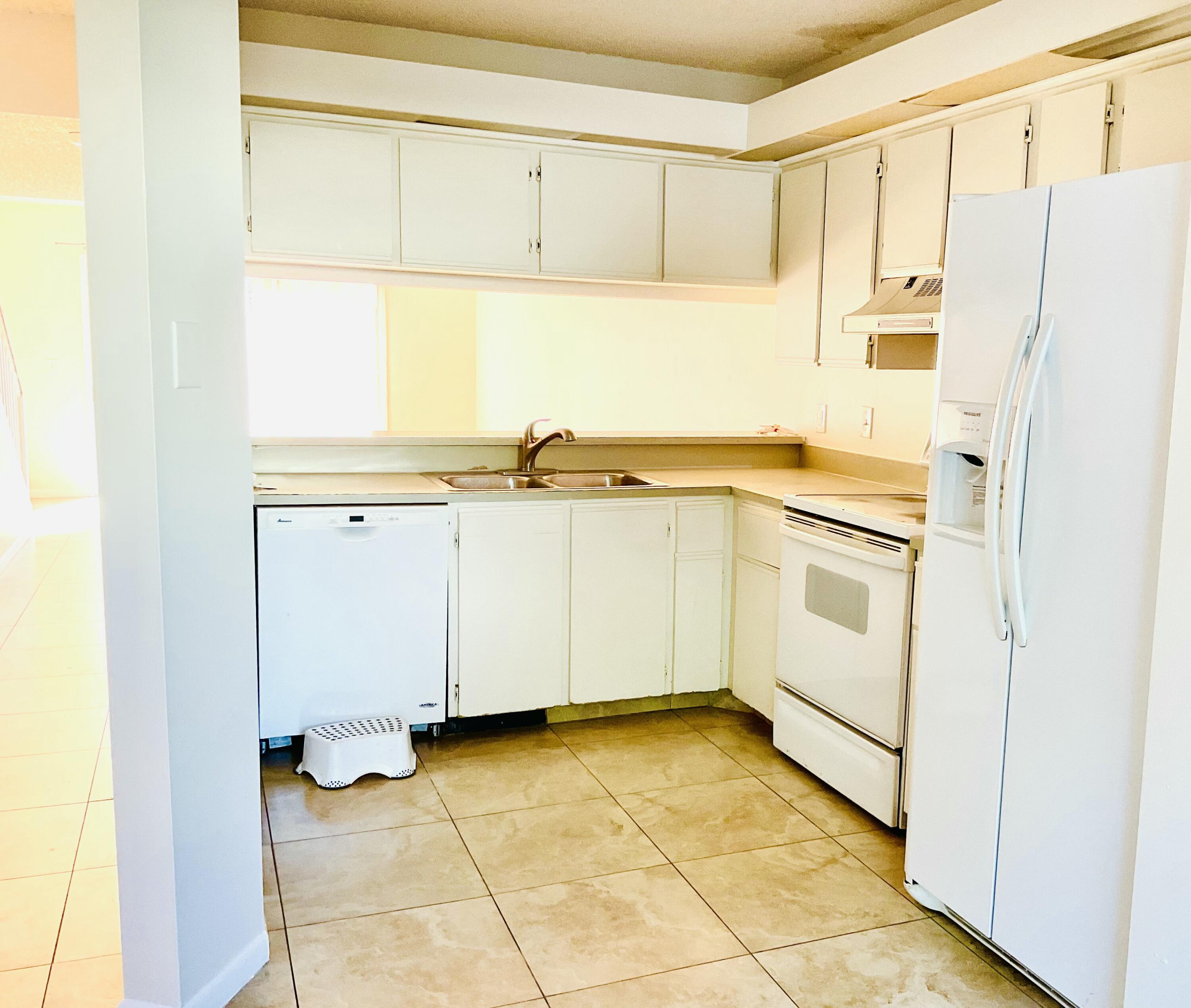 6262 Riverwalk Lane, Unit 3 Jupiter, FL 33458 - Photo 4 of 28 a view of a kitchen with white cabinets