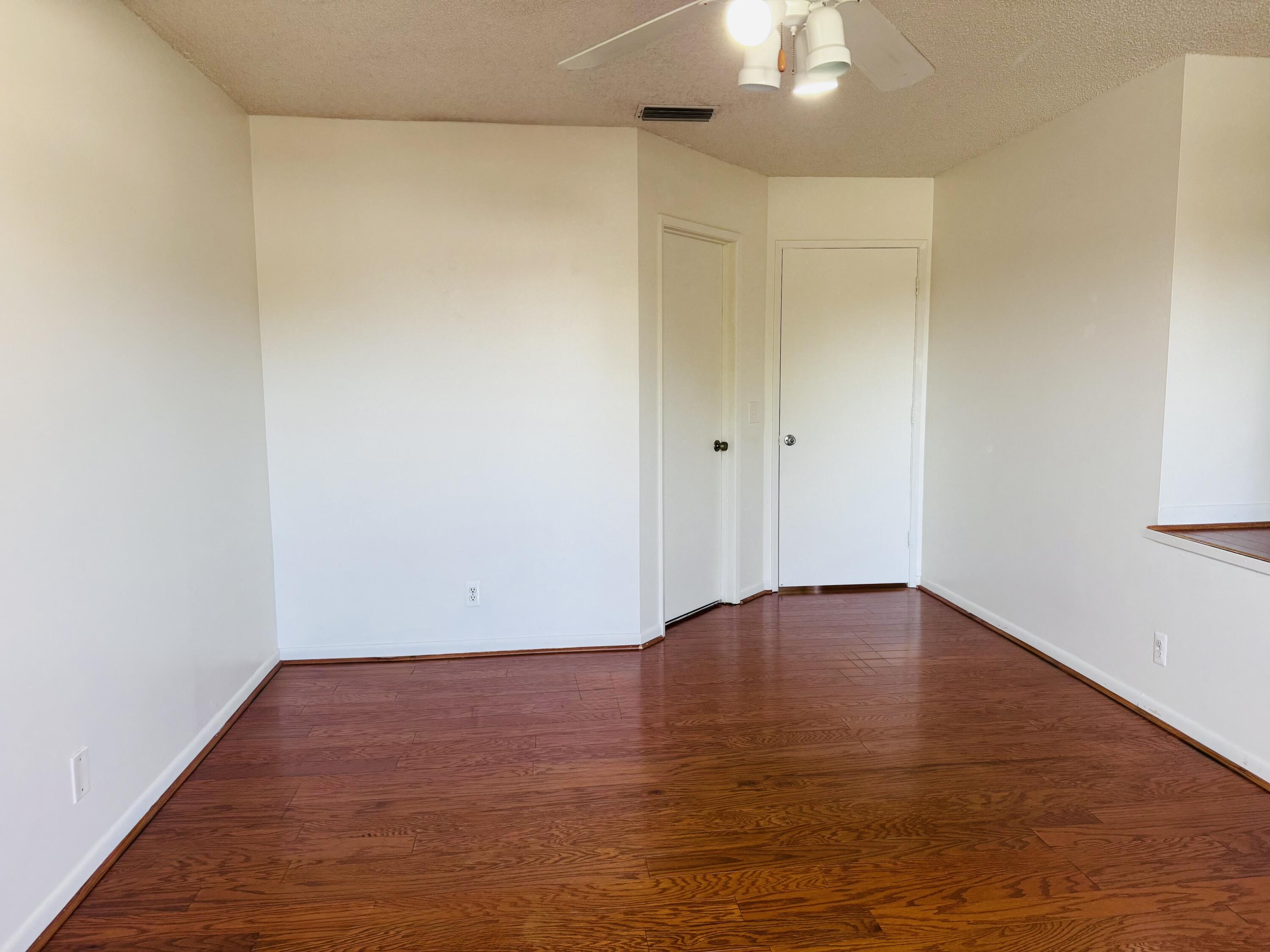 6262 Riverwalk Lane, Unit 3 Jupiter, FL 33458 - Photo 6 of 28 a view of an empty room with a chandelier fan