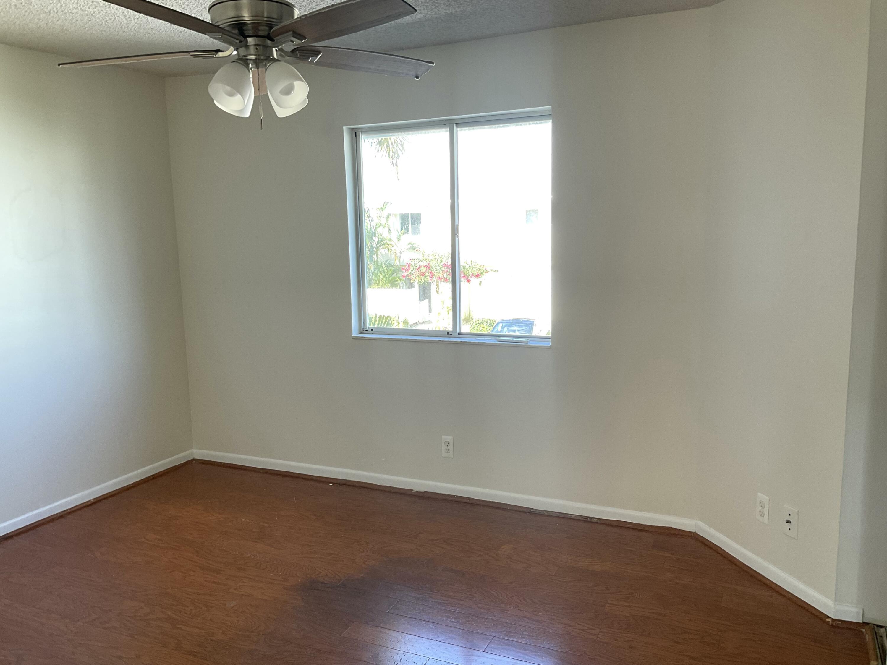 6262 Riverwalk Lane, Unit 3 Jupiter, FL 33458 - Photo 8 of 28 an empty room with a window