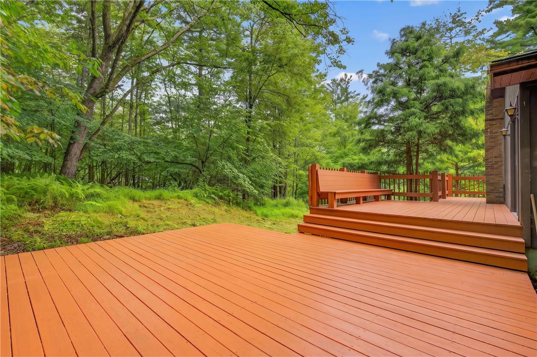 1570 Astolat Road Effort, PA 18330 - Photo 47 of 48 Multi-level wooden decking overlooks a lushly wooded backyard oasis.