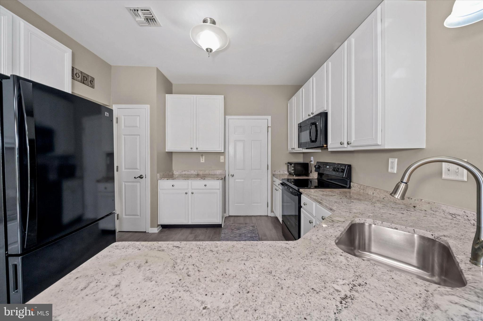 20 Hunters Way Glen Mills, PA 19342 - Photo 13 of 36 a kitchen with stainless steel appliances granite countertop a refrigerator a stove top oven a sink and dishwasher