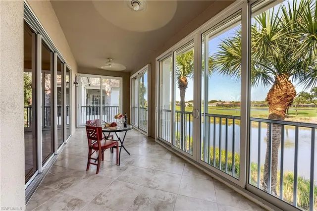 a view of a patio with table and chairs and floor to ceiling window