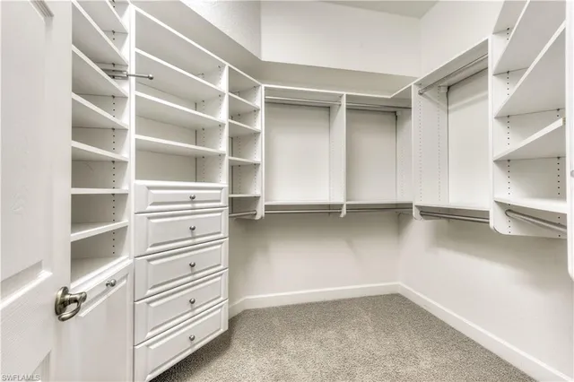 a view of walk in closet with empty racks