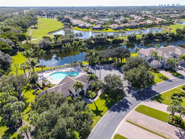 an aerial view of residential houses with outdoor space and swimming pool