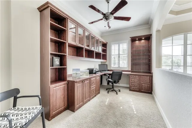 a view of a workspace with furniture and a window