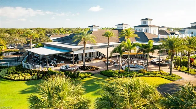 a view of a swimming pool with outdoor seating and a yard