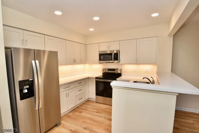 a kitchen with a refrigerator sink and stove