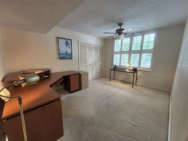 a livingroom with workspace and a window