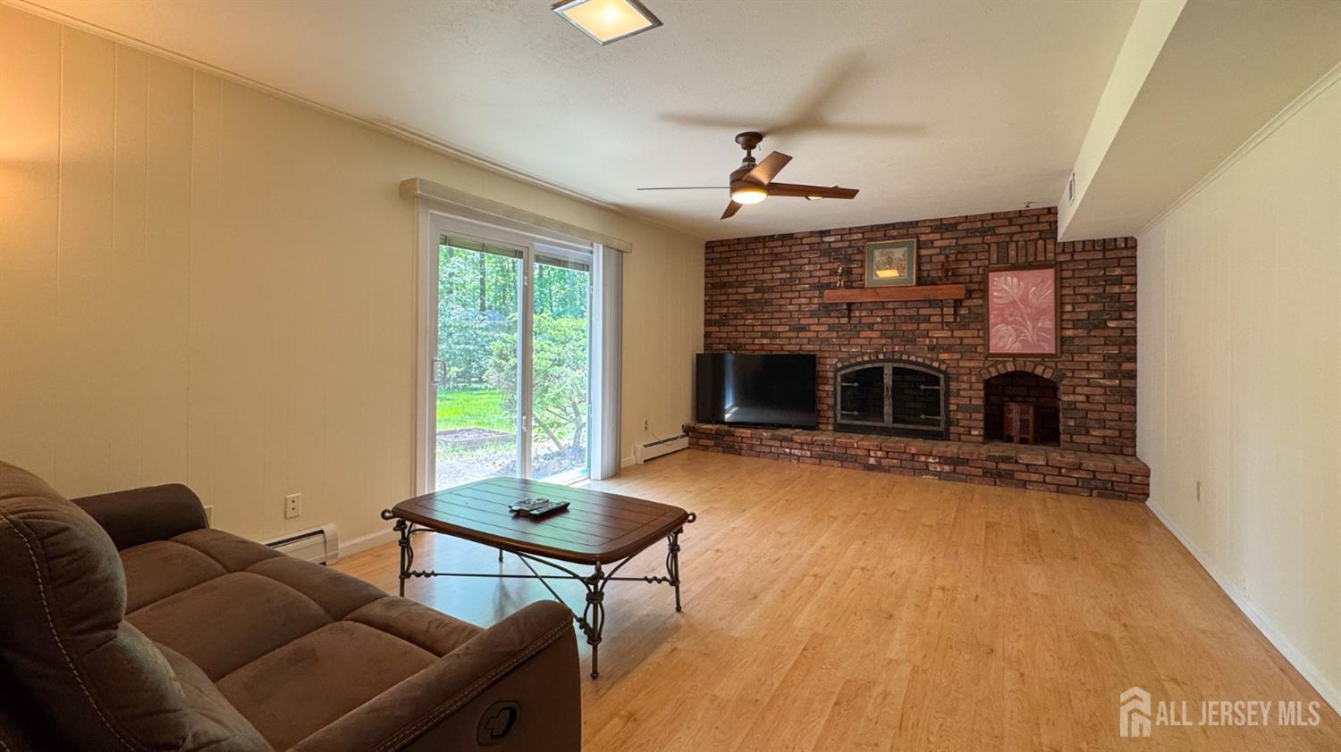 25 Sherwood Road Edison, NJ 08820 - Photo 17 of 25 a living room with furniture a fireplace and a flat screen tv
