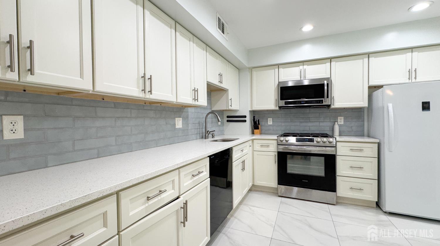 25 Sherwood Road Edison, NJ 08820 - Photo 4 of 25 a kitchen with stainless steel appliances granite countertop a sink stove and refrigerator