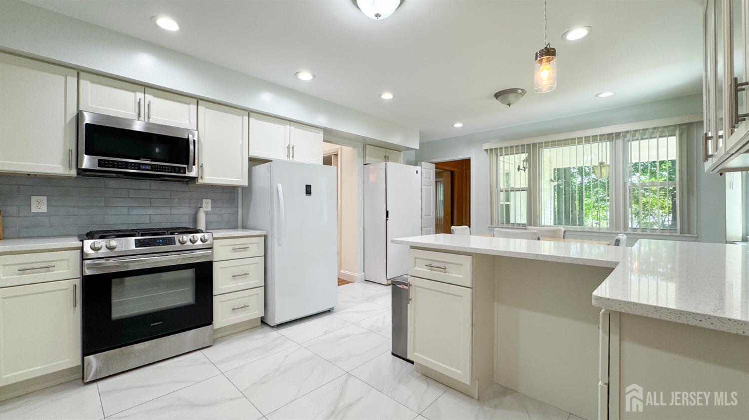25 Sherwood Road Edison, NJ 08820 - Photo 5 of 25 a kitchen with stainless steel appliances granite countertop a stove a sink and a microwave