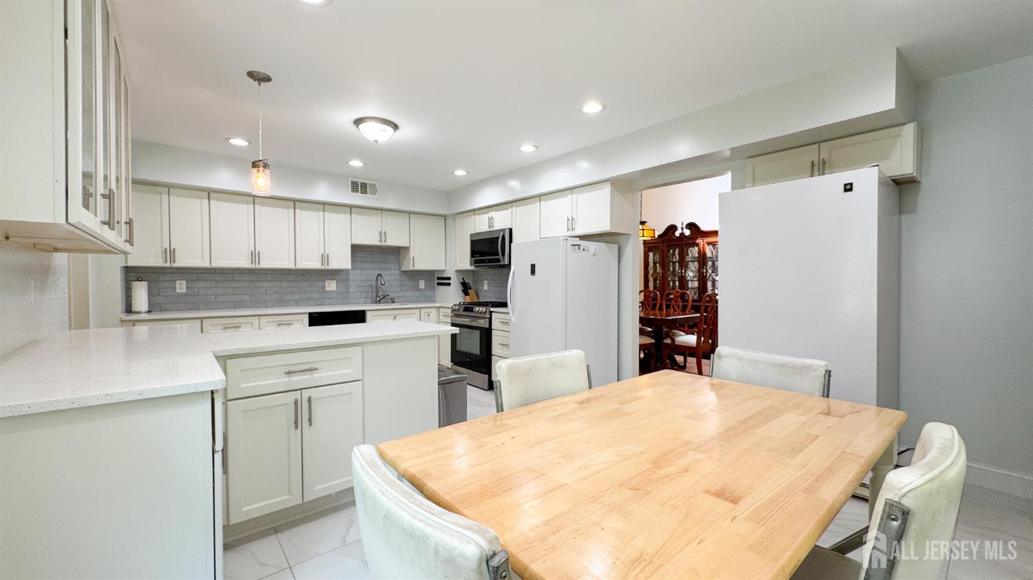 25 Sherwood Road Edison, NJ 08820 - Photo 7 of 25 a kitchen with refrigerator and cabinets