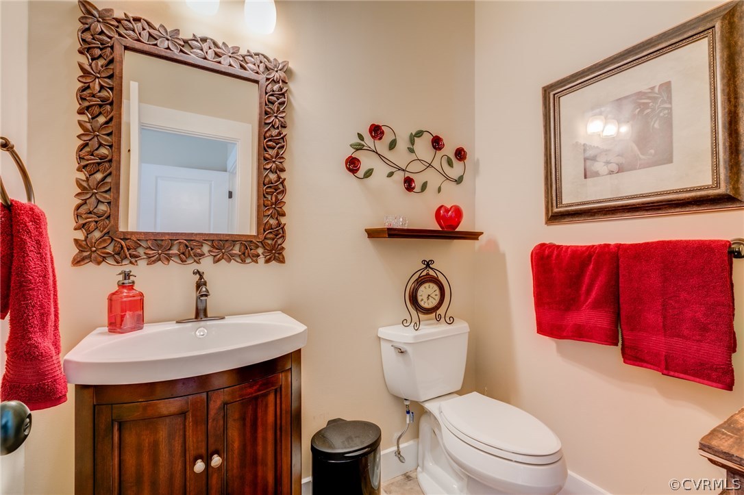 3401 Mill Quarter Road Ford, VA 23850 - Photo 21 of 34 a bathroom with a toilet a sink and a mirror